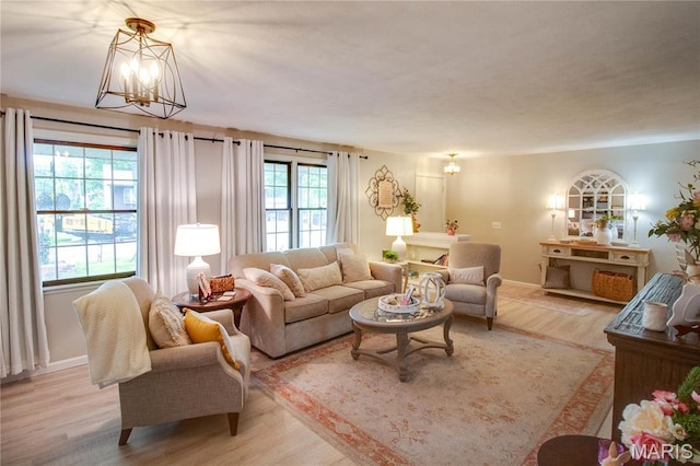 2332 Chadwick Dr, Alton, IL 62002 - living room with a chandelier, light wood-style floors, and baseboards