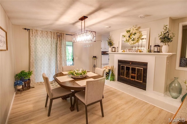 2332 Chadwick Dr, Alton, IL 62002 - dining room featuring light wood-style flooring, a fireplace, a chandelier, and baseboards