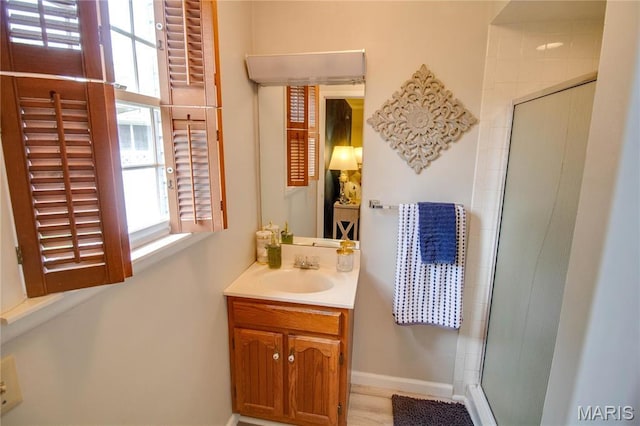 2332 Chadwick Dr, Alton, IL 62002 - full bathroom with healthy amount of natural light, a shower stall, vanity, and baseboards