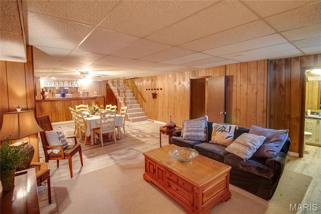 2332 Chadwick Dr, Alton, IL 62002 - living area featuring stairway, a drop ceiling, and wood walls