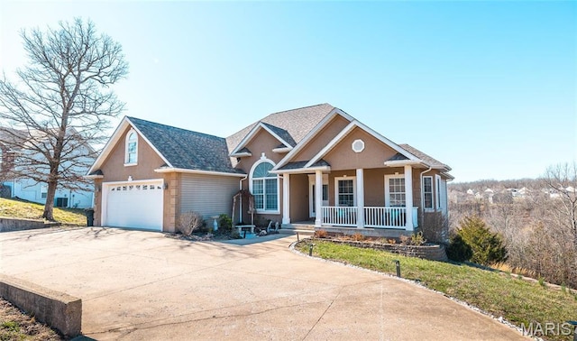 view of front facade with a porch, a garage, and concrete driveway