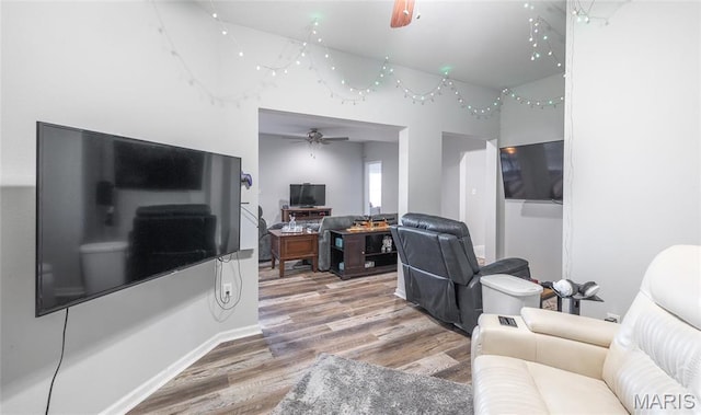 living area featuring ceiling fan and wood finished floors