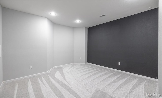 spare room featuring carpet flooring, recessed lighting, and baseboards