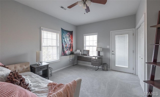 office area with light carpet, ceiling fan, and baseboards
