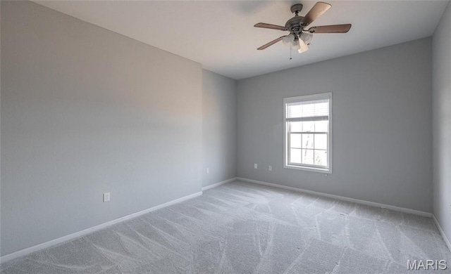 unfurnished room featuring light carpet, baseboards, and ceiling fan