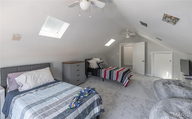 bedroom with light colored carpet, vaulted ceiling, a skylight, and ceiling fan