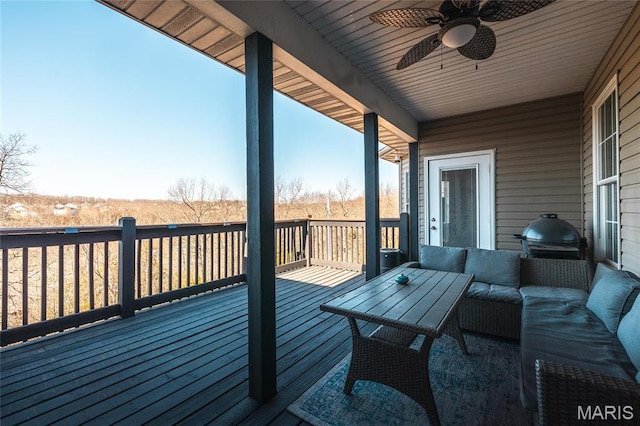wooden terrace featuring an outdoor hangout area, a ceiling fan, and area for grilling