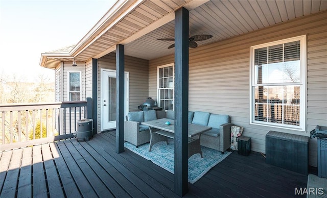 wooden deck with a ceiling fan and outdoor lounge area