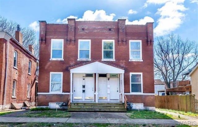 multi unit property with brick siding, entry steps, and fence