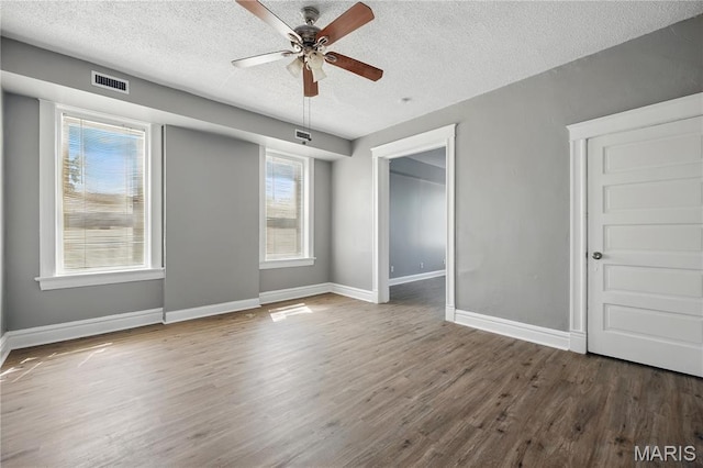 7220 Pennsylvania Ave, Saint Louis, MO 63111 - unfurnished bedroom featuring a textured ceiling, wood finished floors, baseboards, and ceiling fan