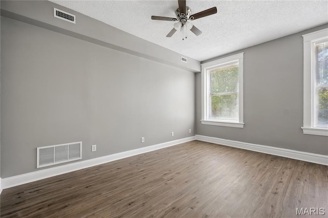 7220 Pennsylvania Ave, Saint Louis, MO 63111 - unfurnished room with a textured ceiling, wood finished floors, ceiling fan, plenty of natural light, and baseboards
