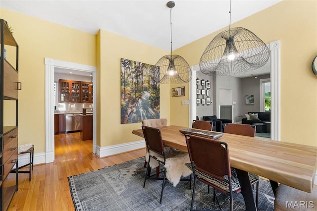 dining room featuring light wood-style flooring and baseboards