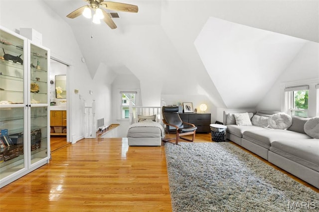 living room with lofted ceiling, light wood-type flooring, plenty of natural light, and ceiling fan