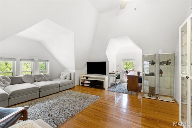 living room with vaulted ceiling, wood finished floors, and ceiling fan