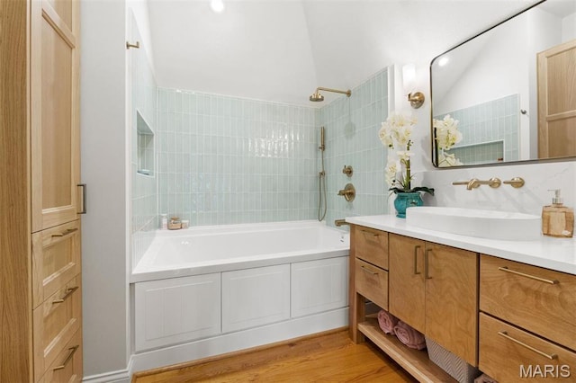 bathroom with vanity, shower / bath combination, and wood finished floors