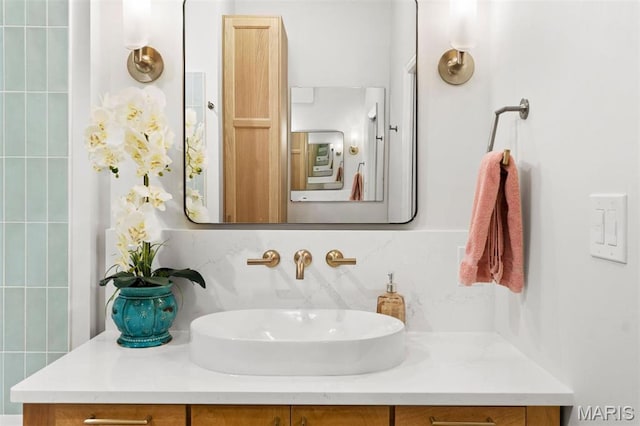 bathroom featuring vanity and backsplash