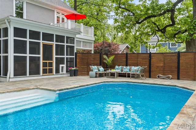 view of pool featuring outdoor lounge area, a patio area, and a fenced backyard