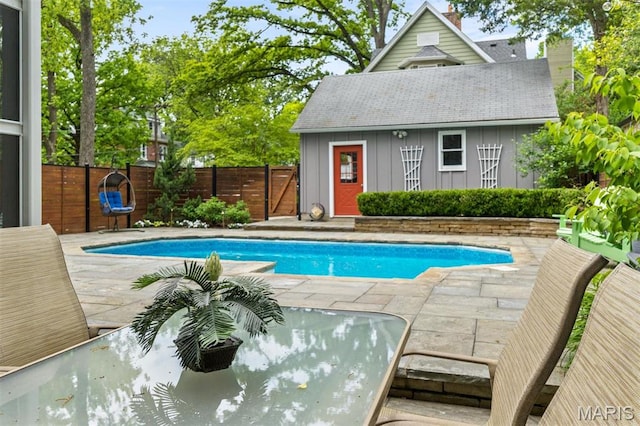 view of pool featuring fence, a patio area, and an outdoor structure