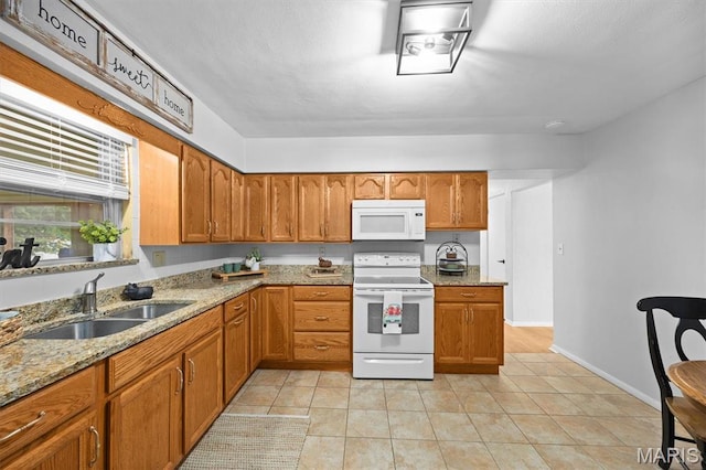 22 Briarwood Dr, Belleville, IL 62223 - kitchen featuring white appliances, a sink, brown cabinets, light stone countertops, and light tile patterned floors