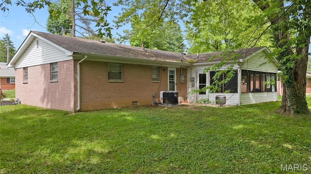 22 Briarwood Dr, Belleville, IL 62223 - rear view of house with a sunroom, central AC, a lawn, and brick siding
