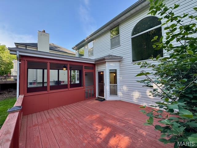 650 Legends View Dr, Eureka, MO 63025 - back of property with a wooden deck, a chimney, and a sunroom
