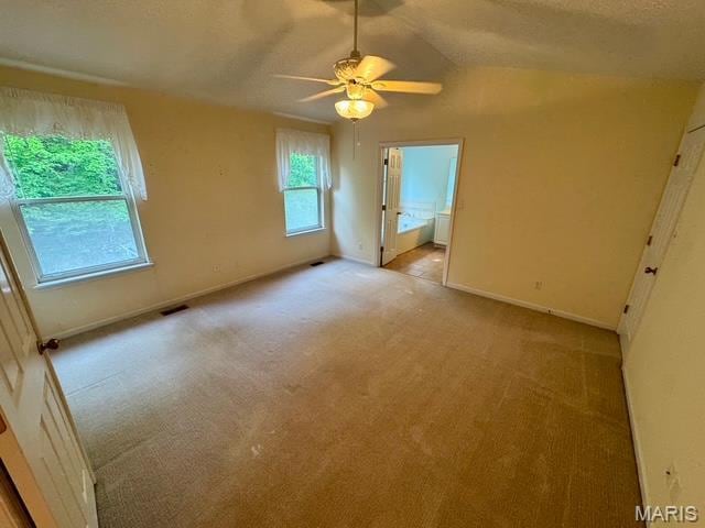 650 Legends View Dr, Eureka, MO 63025 - unfurnished bedroom featuring light colored carpet, baseboards, lofted ceiling, ensuite bathroom, and a ceiling fan