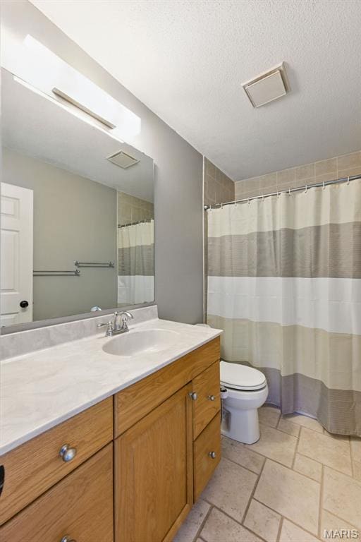 bathroom featuring vanity, toilet, stone tile floors, and a shower with shower curtain