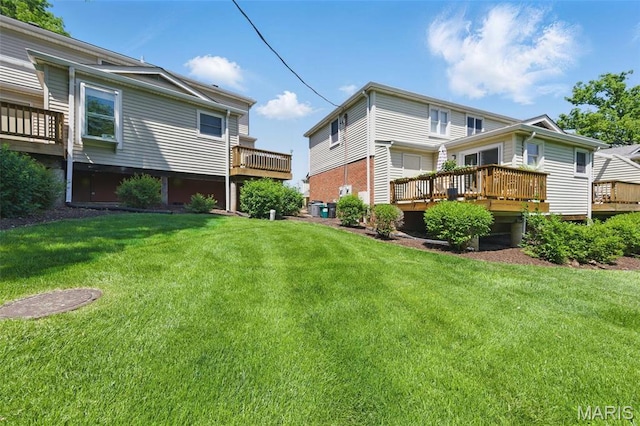 back of house with a deck and a yard