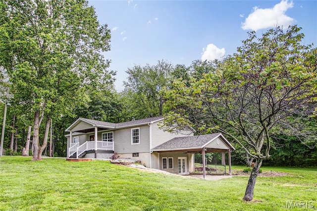 rear view of house with a lawn, french doors, and a porch