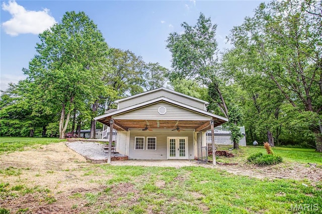 back of house with french doors, ceiling fan, a lawn, and a patio area