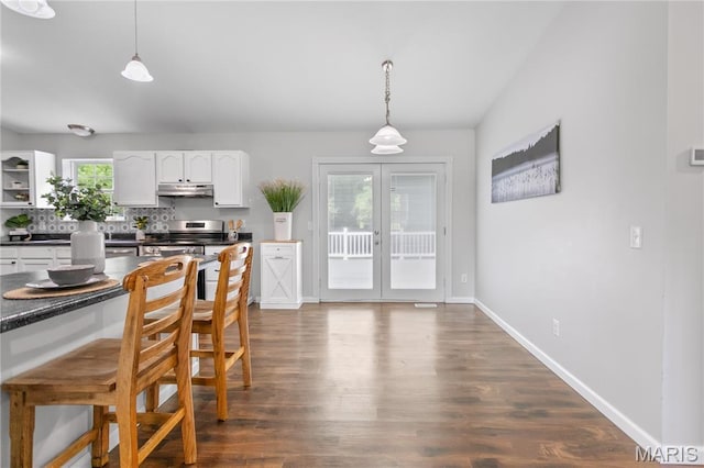 dining room with dark wood-style flooring, french doors, and baseboards