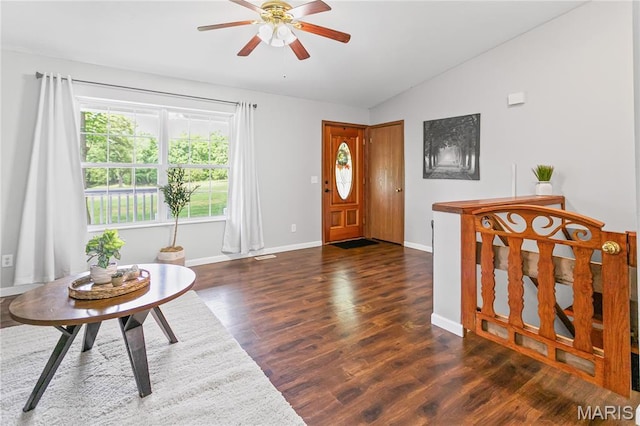 entryway featuring lofted ceiling, ceiling fan, wood finished floors, and baseboards