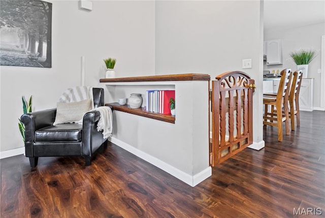 living area with wood finished floors and baseboards