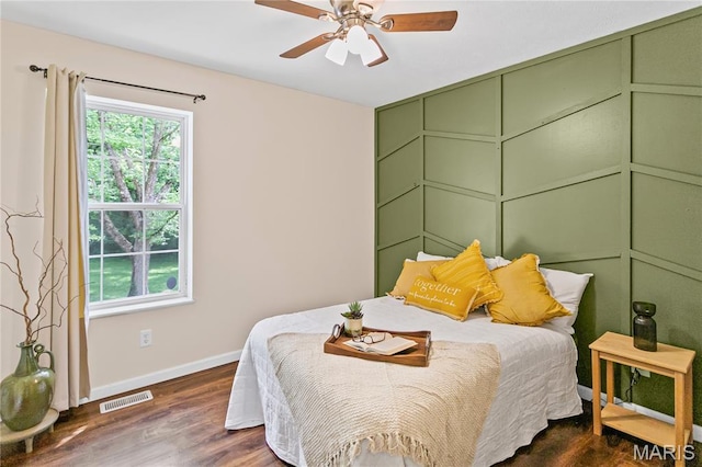 bedroom featuring baseboards, dark wood-type flooring, and ceiling fan