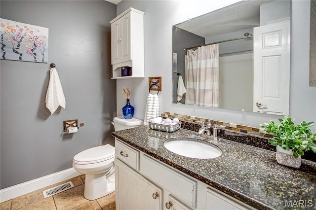 bathroom with baseboards, toilet, vanity, tile patterned flooring, and a shower with shower curtain