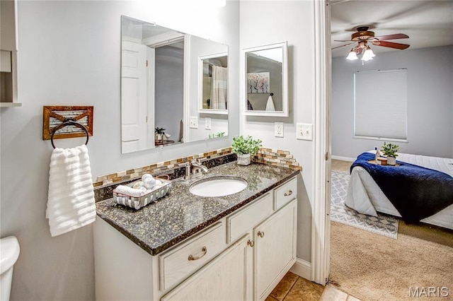bathroom with ceiling fan, vanity, baseboards, and tile patterned flooring