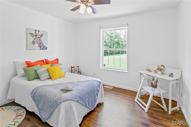 bedroom featuring wood finished floors, baseboards, and ceiling fan