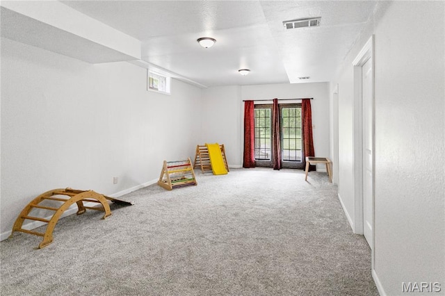 recreation room with carpet and baseboards
