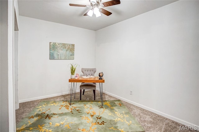 office area with carpet flooring, a ceiling fan, and baseboards