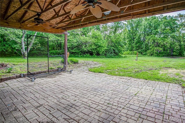 view of patio / terrace featuring ceiling fan and a forest view