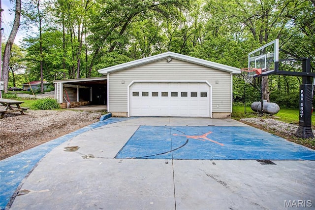 garage with a detached garage and view of scattered trees