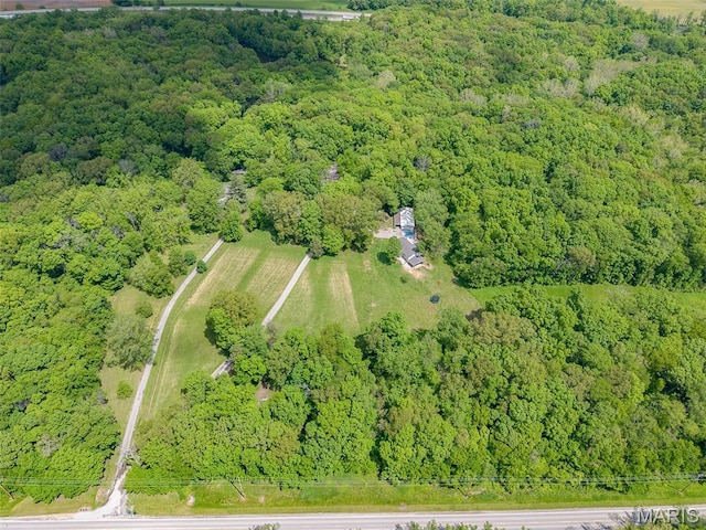aerial overview of property's location with a heavily wooded area