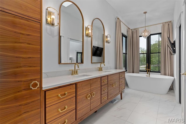 10028 Pineridge Dr, Effingham, IL 62401 - bathroom with double vanity, a freestanding tub, marble finish floors, and a chandelier