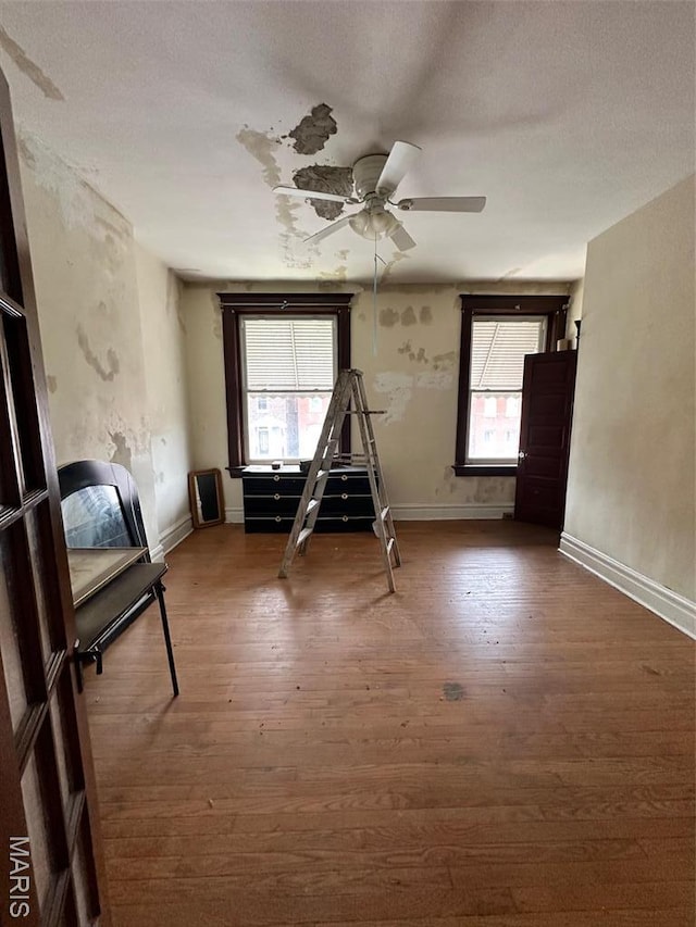 3636 Arkansas Ave, Saint Louis, MO 63118 - unfurnished bedroom with wood finished floors, baseboards, and a ceiling fan