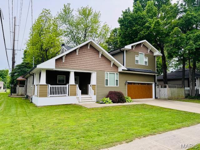 121 E Missouri St, Benton, MO 63736 - view of front facade with a porch, an attached garage, and driveway