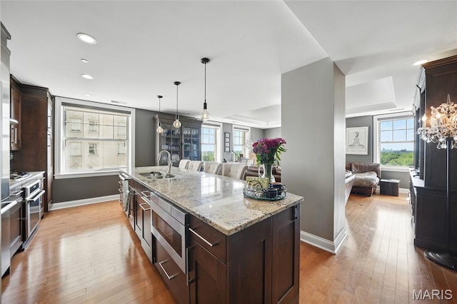 232 N Kingshighway Blvd Unit 907, Saint Louis, MO 63108 - kitchen with open floor plan, light wood finished floors, dark brown cabinetry, and recessed lighting