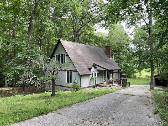 236 Mohawk Dr, Cape Girardeau, MO 63701 - a-frame home featuring a chimney, roof with shingles, asphalt driveway, and covered porch