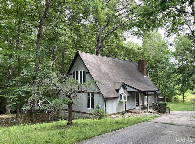 236 Mohawk Dr, Cape Girardeau, MO 63701 - a-frame home featuring a shingled roof, a chimney, and covered porch