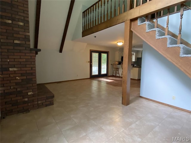 236 Mohawk Dr, Cape Girardeau, MO 63701 - unfurnished living room featuring a towering ceiling, baseboards, and beamed ceiling