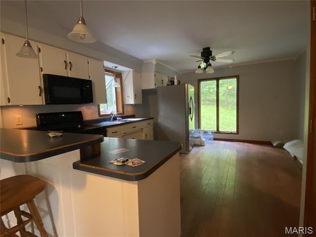 236 Mohawk Dr, Cape Girardeau, MO 63701 - kitchen with black appliances, dark countertops, healthy amount of natural light, and white cabinets